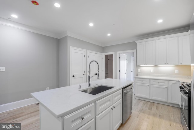 kitchen featuring a sink, dishwasher, range with gas cooktop, white cabinetry, and light wood-style floors