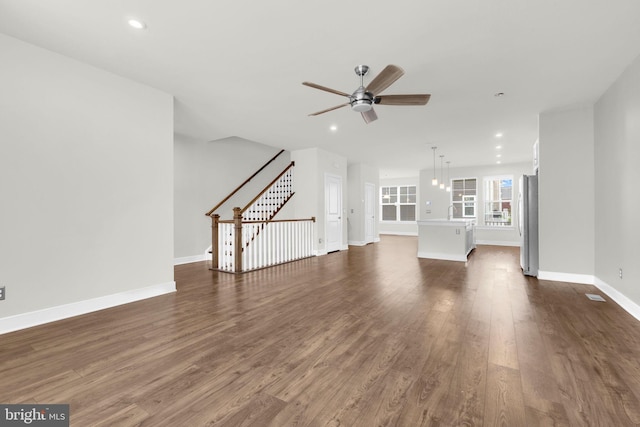 1552 Meadowlark Glen Rd, Dumfries, VA 22026 - unfurnished living room with dark wood-style flooring, a ceiling fan, stairs, baseboards, and recessed lighting