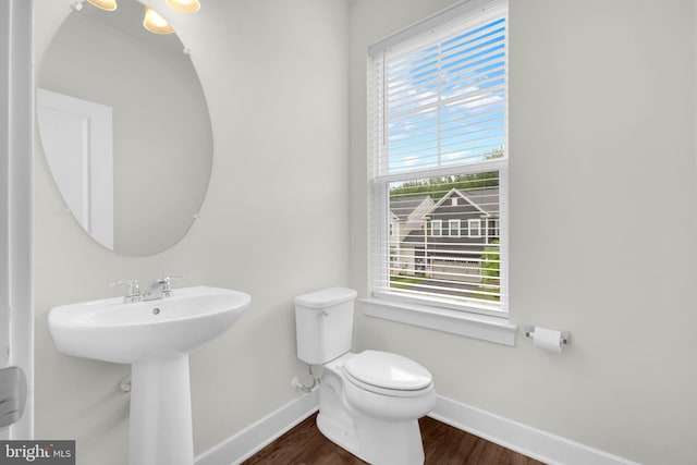 1552 Meadowlark Glen Rd, Dumfries, VA 22026 - bathroom with baseboards, wood finished floors, toilet, and a sink