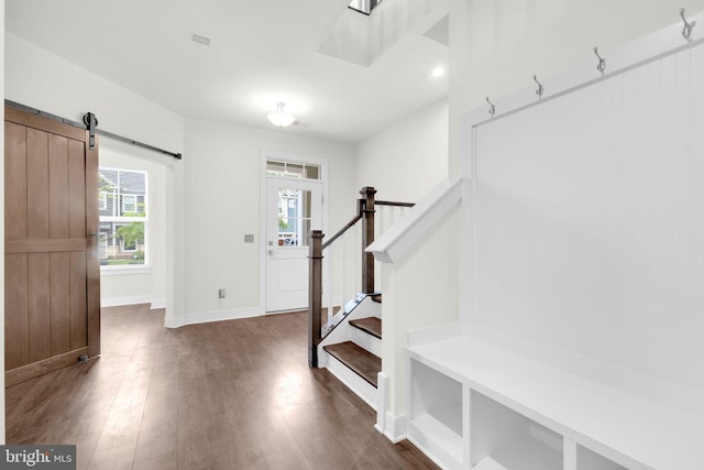 1552 Meadowlark Glen Rd, Dumfries, VA 22026 - foyer entrance featuring a barn door, dark wood finished floors, stairway, and baseboards