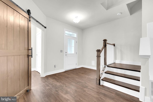 1552 Meadowlark Glen Rd, Dumfries, VA 22026 - entryway with a barn door, dark wood-style flooring, baseboards, and stairs