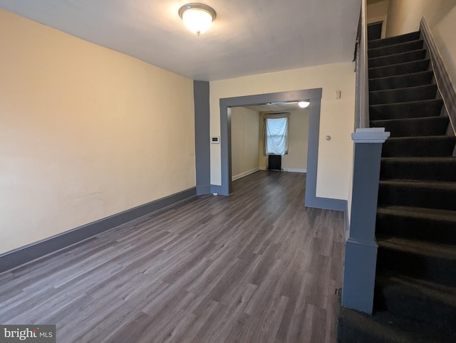4133 Eierman Ave, Baltimore, MD 21206 - unfurnished living room with dark wood-type flooring, stairway, and baseboards