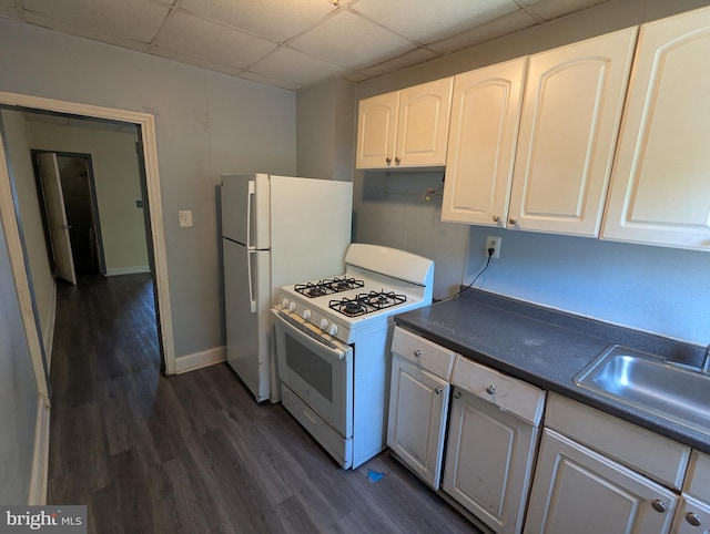 4133 Eierman Ave, Baltimore, MD 21206 - kitchen with white appliances, dark countertops, a sink, dark wood-type flooring, and a paneled ceiling