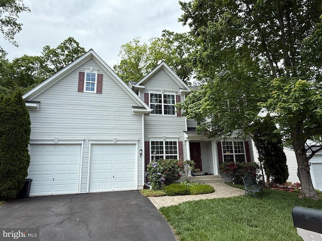 5280 Gunston Hall Dr, Woodbridge, VA 22193 - traditional home with driveway, an attached garage, and a front yard