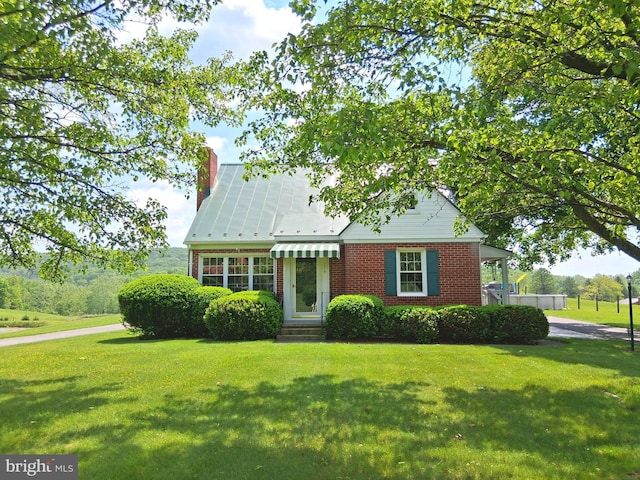 234 Bethel Grange Rd, Winchester, VA 22603 - view of front facade with brick siding, a front lawn, and a chimney
