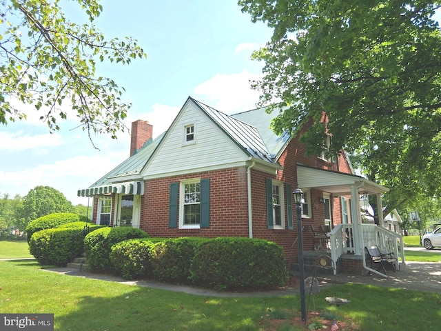 234 Bethel Grange Rd, Winchester, VA 22603 - view of front of property featuring brick siding, a chimney, a front lawn, a standing seam roof, and metal roof