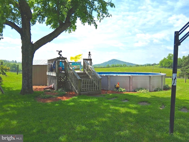 234 Bethel Grange Rd, Winchester, VA 22603 - view of play area with an outdoor pool, a yard, stairway, and a mountain view