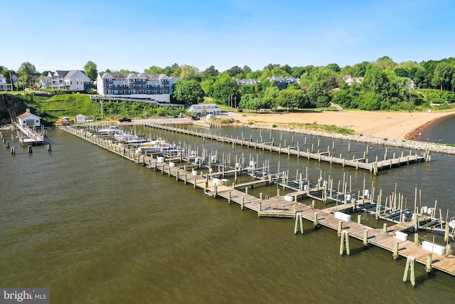 dock area with a water view and view of wooded area