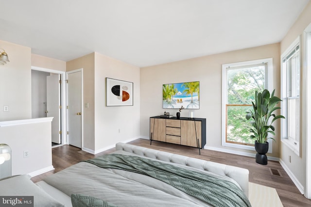 bedroom featuring wood finished floors and baseboards
