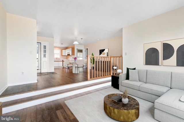 living area featuring wood finished floors and baseboards