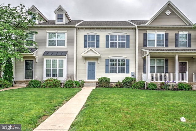 view of property featuring a front lawn and covered porch
