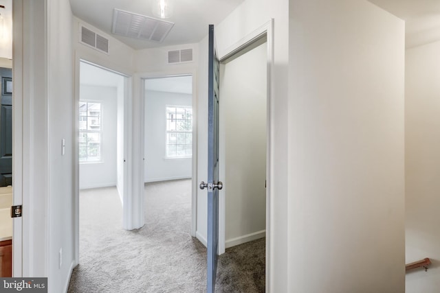 hallway featuring carpet floors and baseboards