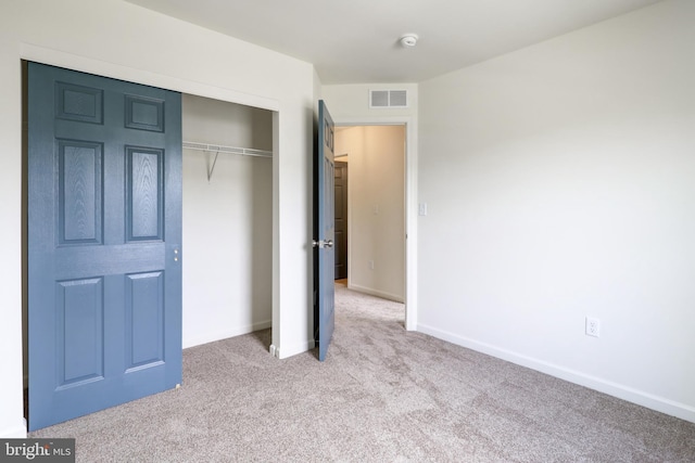 unfurnished bedroom featuring carpet floors, a closet, and baseboards