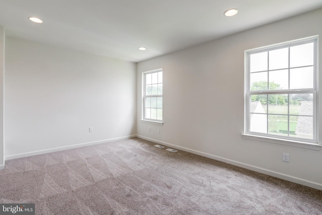 carpeted spare room with baseboards and recessed lighting