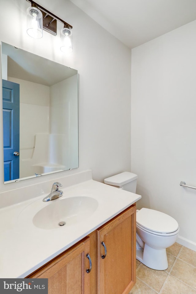 bathroom with tile patterned floors, vanity, and toilet