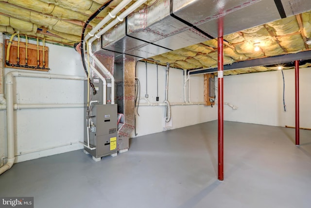 unfinished below grade area featuring heating unit