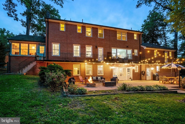 104 River Forest Ln, Fort Washington, MD 20744 - back of house with an outdoor living space with a fire pit, a patio, a yard, stairs, and brick siding