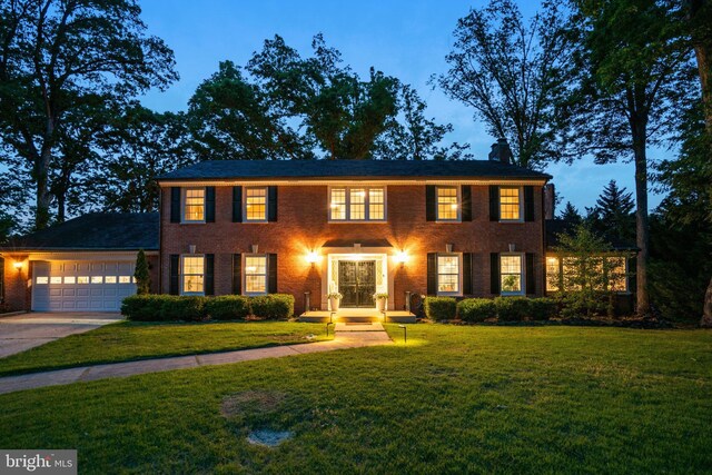 104 River Forest Ln, Fort Washington, MD 20744 - colonial-style house with an attached garage, a front yard, concrete driveway, and brick siding
