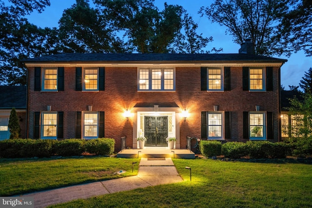 104 River Forest Ln, Fort Washington, MD 20744 - view of front of house featuring a chimney, a front lawn, and brick siding
