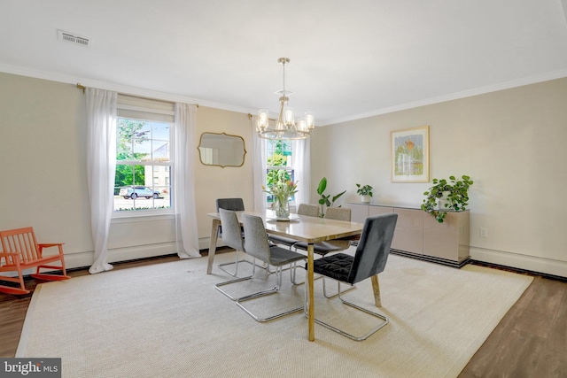 104 River Forest Ln, Fort Washington, MD 20744 - dining room with a chandelier, light wood-style flooring, plenty of natural light, ornamental molding, and a baseboard heating unit
