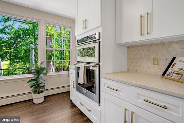 104 River Forest Ln, Fort Washington, MD 20744 - kitchen with stainless steel double oven, plenty of natural light, tasteful backsplash, and white cabinets