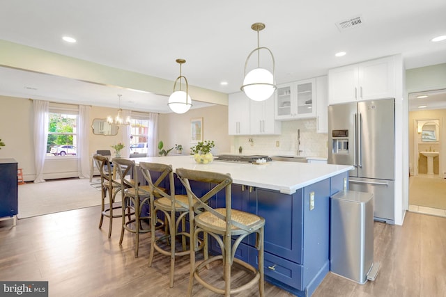 104 River Forest Ln, Fort Washington, MD 20744 - kitchen with stainless steel fridge, a sink, white cabinetry, light wood-type flooring, and recessed lighting