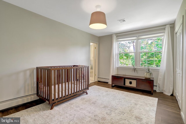 104 River Forest Ln, Fort Washington, MD 20744 - bedroom with a baseboard radiator and wood finished floors