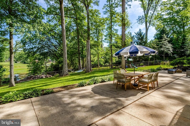 104 River Forest Ln, Fort Washington, MD 20744 - view of patio with outdoor dining area, a playground, and view of scattered trees