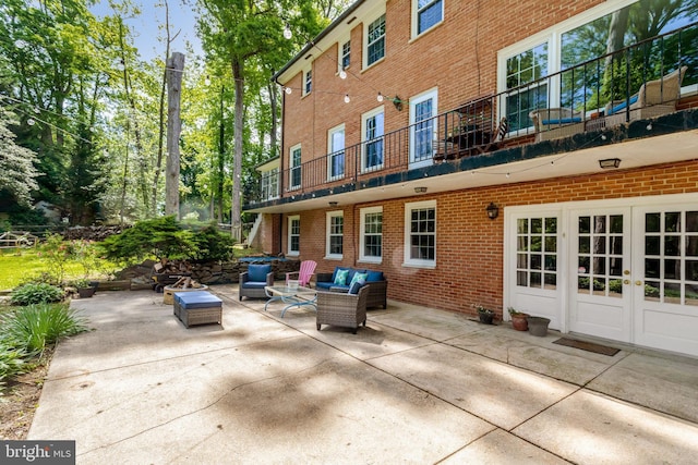 104 River Forest Ln, Fort Washington, MD 20744 - back of property with brick siding, a patio area, french doors, outdoor lounge area, and a balcony