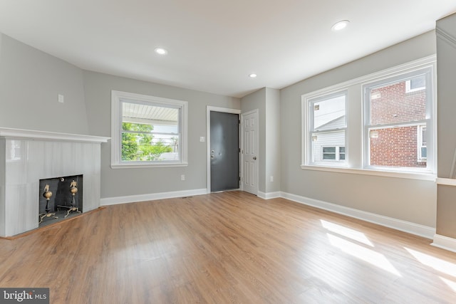 unfurnished living room featuring light wood finished floors, baseboards, and recessed lighting