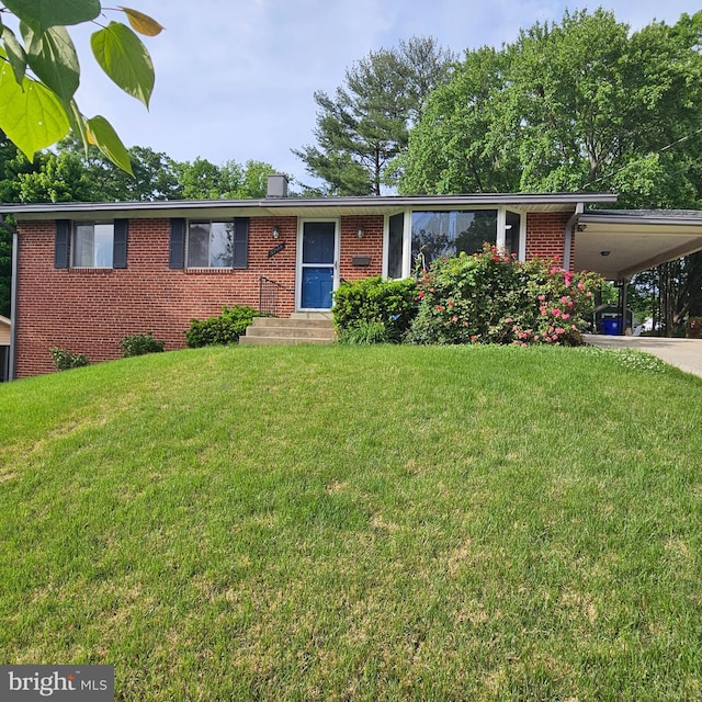 ranch-style house featuring brick siding, a chimney, a front lawn, a carport, and entry steps