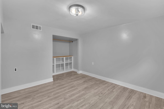 empty room with light wood-style flooring and baseboards
