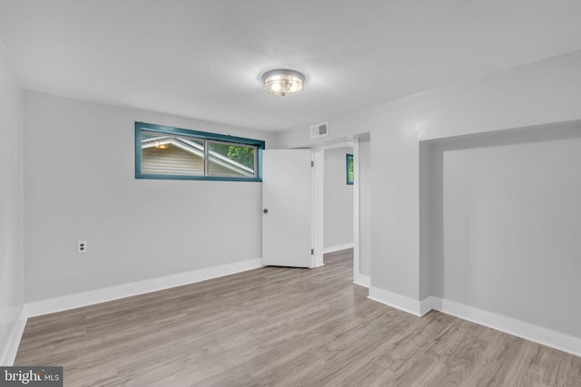 unfurnished room with wood finished floors and baseboards