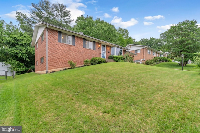 single story home featuring brick siding