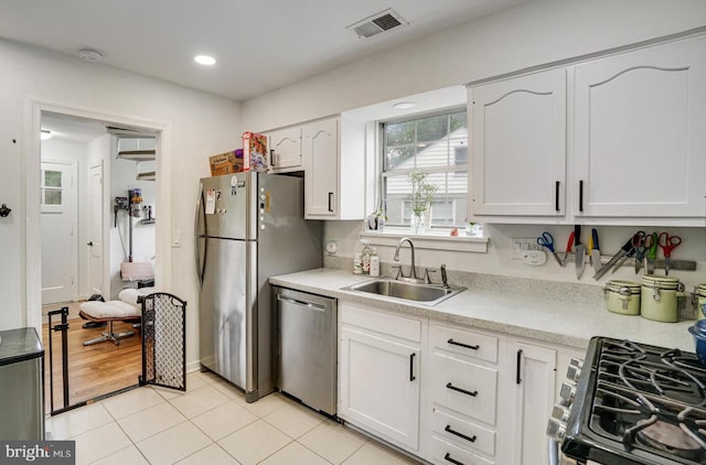 8102 Wingfield Pl, Alexandria, VA 22308 - kitchen featuring stainless steel appliances, a sink, plenty of natural light, white cabinets, and recessed lighting