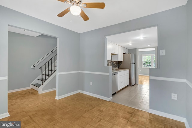 2836 Beechtree Ln, Woodbridge, VA 22191 - empty room with ceiling fan, stairs, baseboards, and a sink