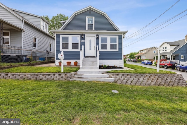 7608 Avondale Ave, Baltimore, MD 21224 - dutch colonial featuring a front lawn, a gambrel roof, and a residential view