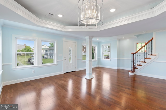 7608 Avondale Ave, Baltimore, MD 21224 - entryway with ornate columns, wood finished floors, a tray ceiling, ornamental molding, and stairs