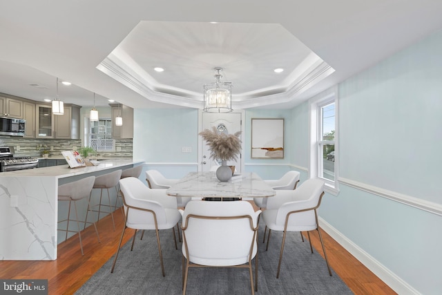 7608 Avondale Ave, Baltimore, MD 21224 - dining room with a tray ceiling, wood finished floors, a chandelier, recessed lighting, and baseboards