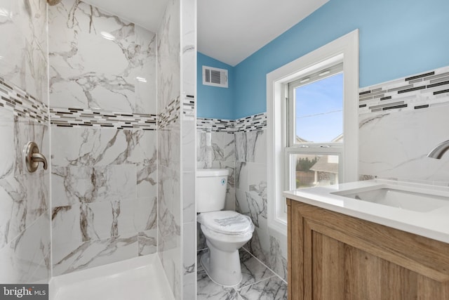 7608 Avondale Ave, Baltimore, MD 21224 - full bathroom featuring marble look tile flooring, tile walls, a shower, toilet, and vanity