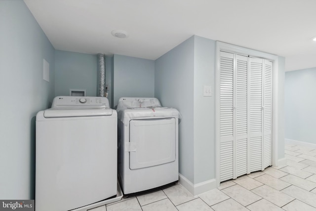 7608 Avondale Ave, Baltimore, MD 21224 - laundry area featuring washer and clothes dryer, baseboards, and light tile patterned floors