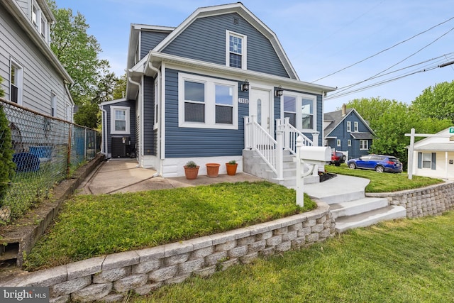 7608 Avondale Ave, Baltimore, MD 21224 - view of front facade with a gambrel roof, central AC unit, and entry steps