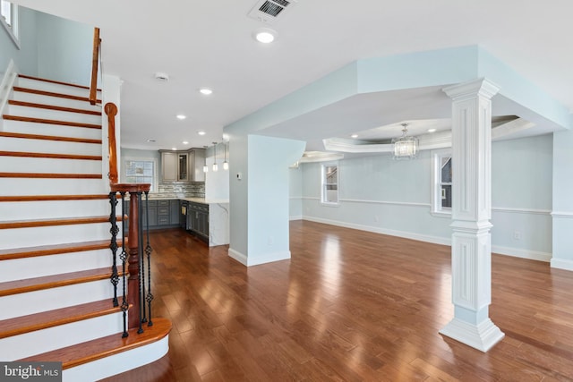 7608 Avondale Ave, Baltimore, MD 21224 - unfurnished living room with ornate columns, recessed lighting, dark wood finished floors, stairs, and baseboards