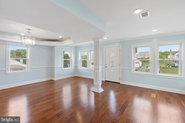 7608 Avondale Ave, Baltimore, MD 21224 - entrance foyer with ornate columns, crown molding, baseboards, a chandelier, and dark wood finished floors