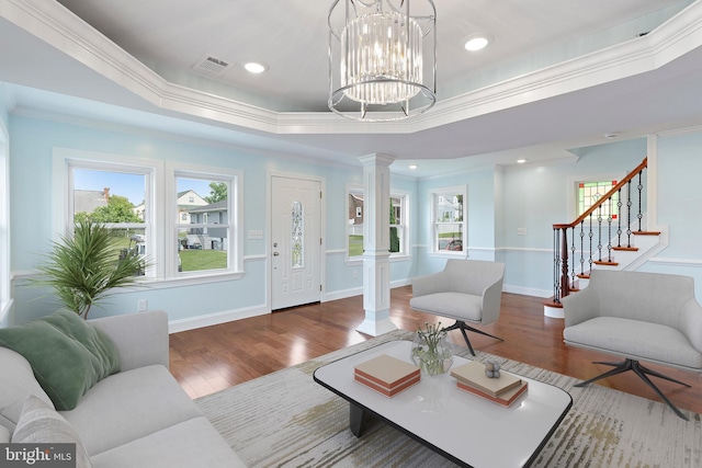 7608 Avondale Ave, Baltimore, MD 21224 - living area featuring decorative columns, ornamental molding, wood finished floors, a tray ceiling, and stairs
