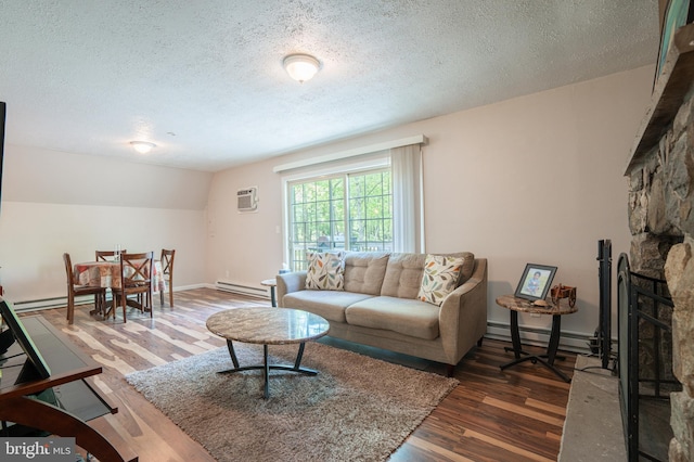 living room with a baseboard heating unit, an AC wall unit, a textured ceiling, wood finished floors, and vaulted ceiling