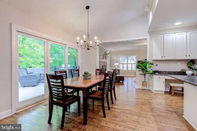 dining area featuring a chandelier, lofted ceiling, light wood-style flooring, baseboards, and recessed lighting