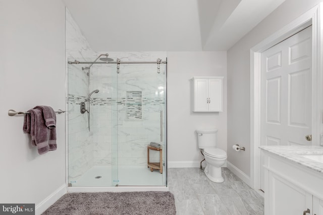 bathroom featuring a shower stall, toilet, and baseboards