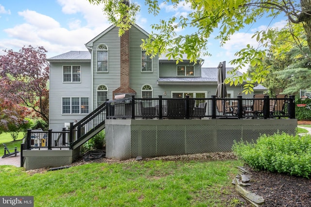 rear view of property with a wooden deck, stairs, and a yard