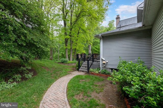 view of grassy yard featuring a wooden deck